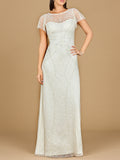 Woman wearing a long, white lace dress against a beige background