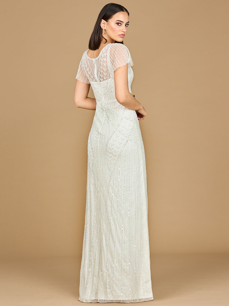 Woman wearing a white lace dress against a beige background